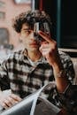 Man Holding Glass of Red Wine in Restaurant