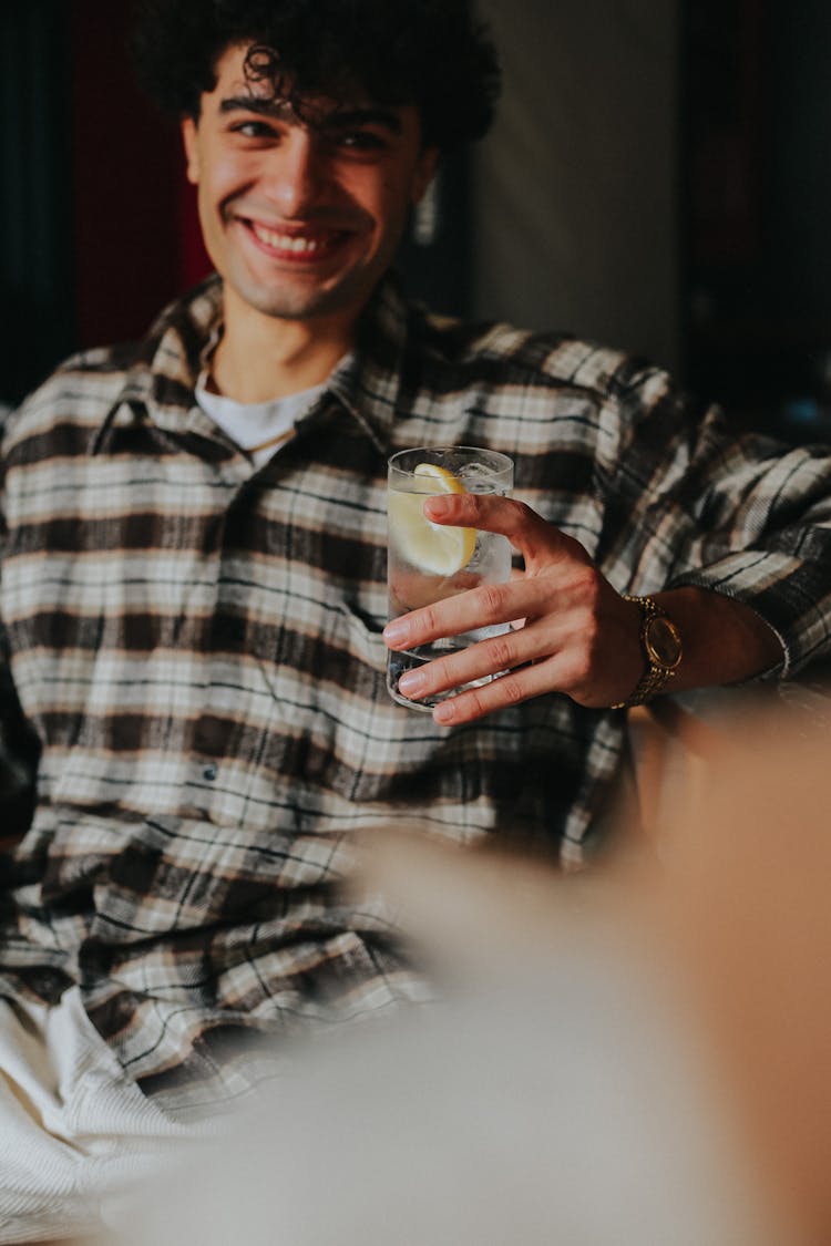 Smiling Man Holding Glass Of Water With Lemon Slice 