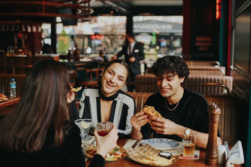 Friends Eating and Drinking in Restaurant