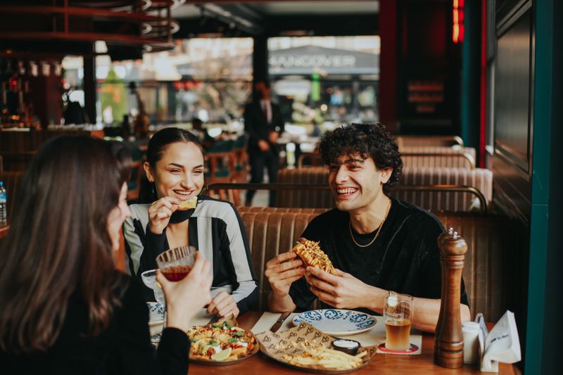 Colleagues sharing a meal at a restaurant table — photo by Taha Samet Arslan on Pexels