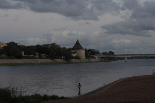 Person Fishing in River at Dawn