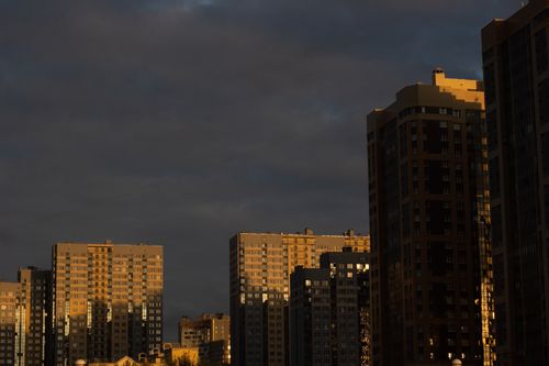 Free Overview of modern high-rise buildings with sunset shadows in a city skyline. Stock Photo
