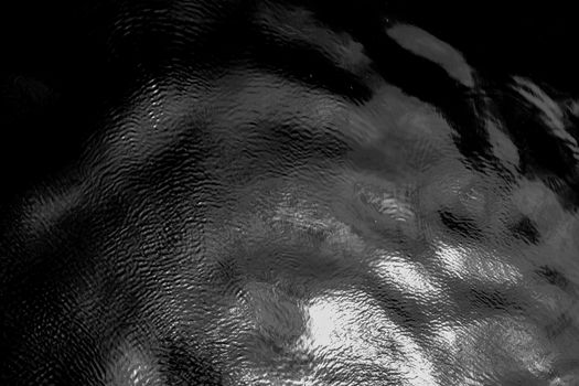 Black and White Photo of a Body of Water with Ripples