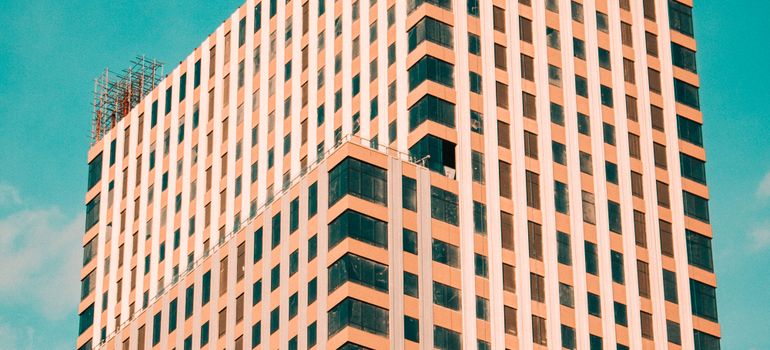Modern office building against blue sky where people moving from Phoenix to Surprise work
