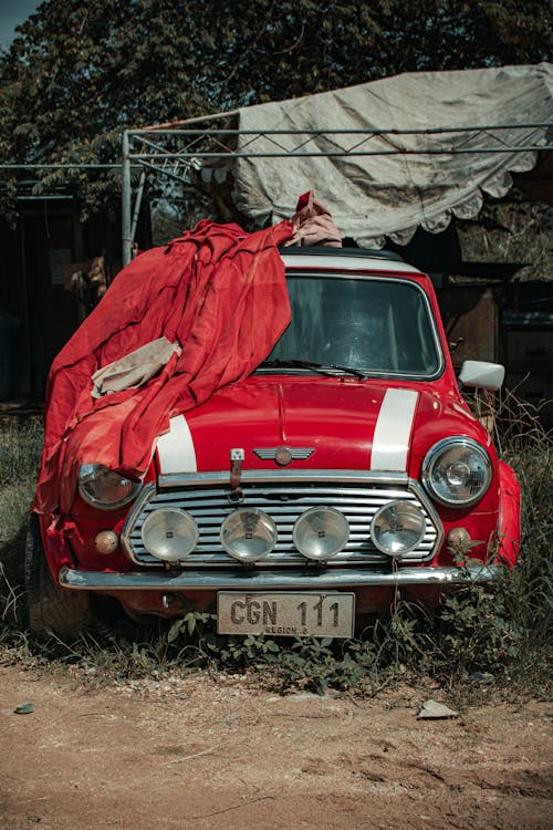 Red Car Parked on Dirt Ground