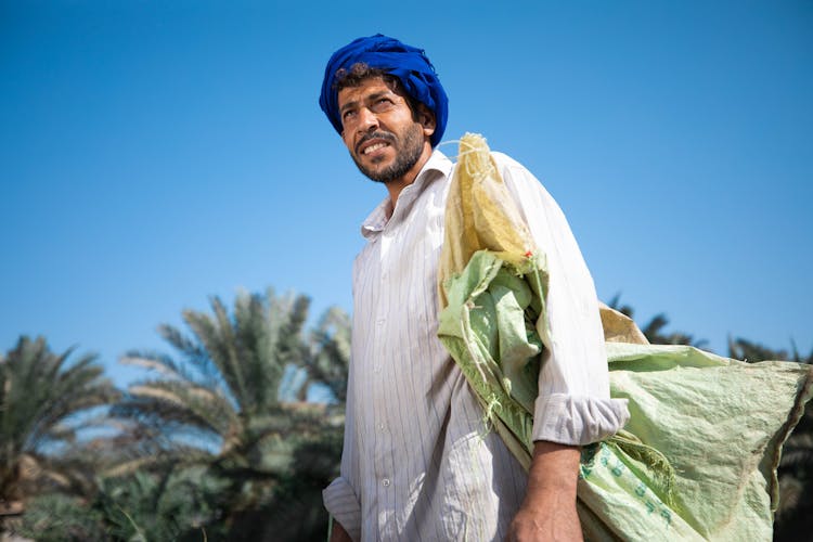 Man Against Palm Trees In Oasis