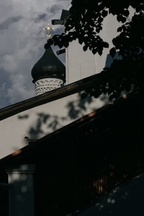 Free Elegantly silhouetted church tower with shadows under a dramatic sky. Stock Photo