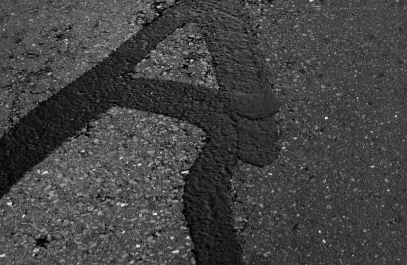 Sealant applied to cracks in asphalt pavement