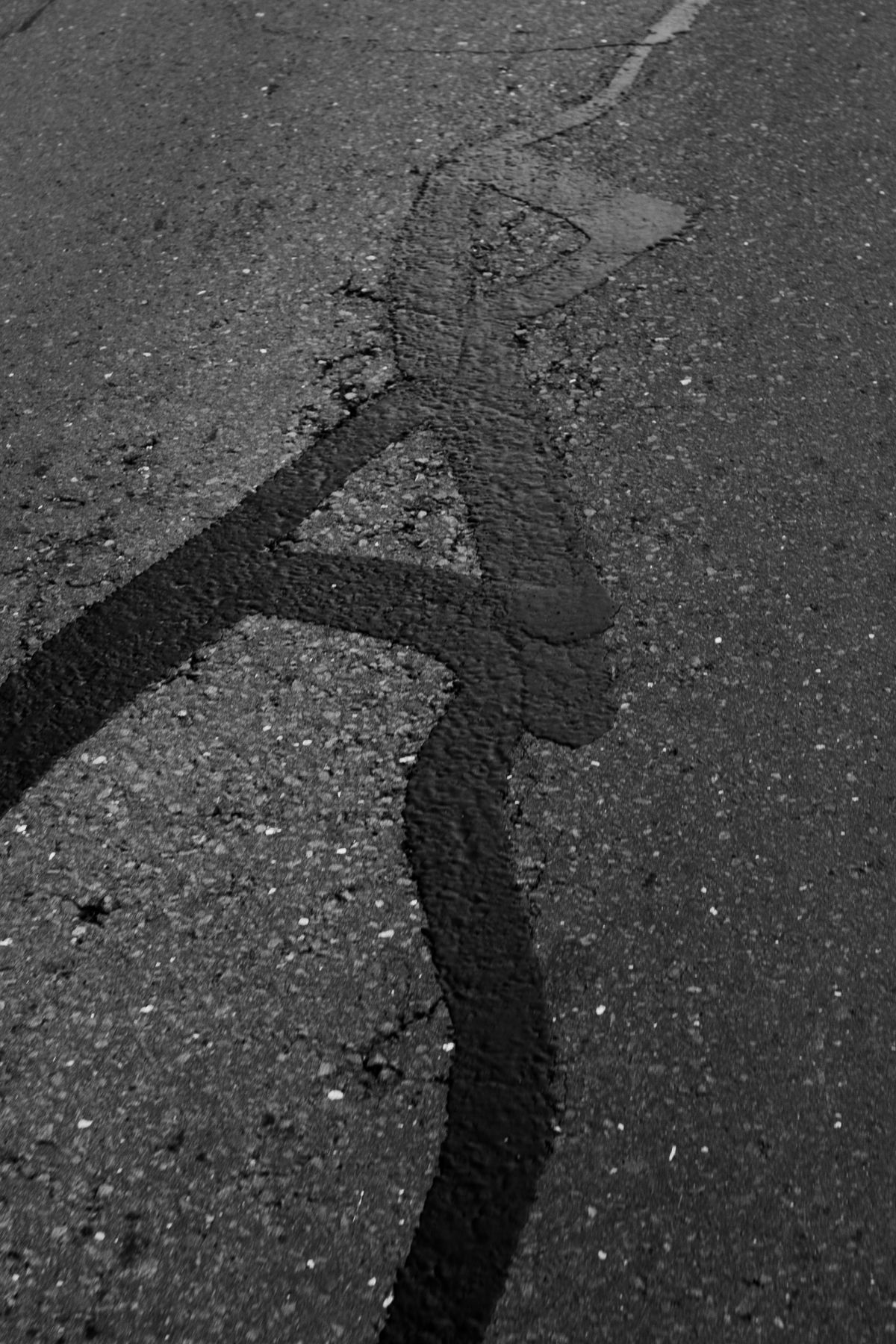 Asphalt surface with cracks sealed during maintenance