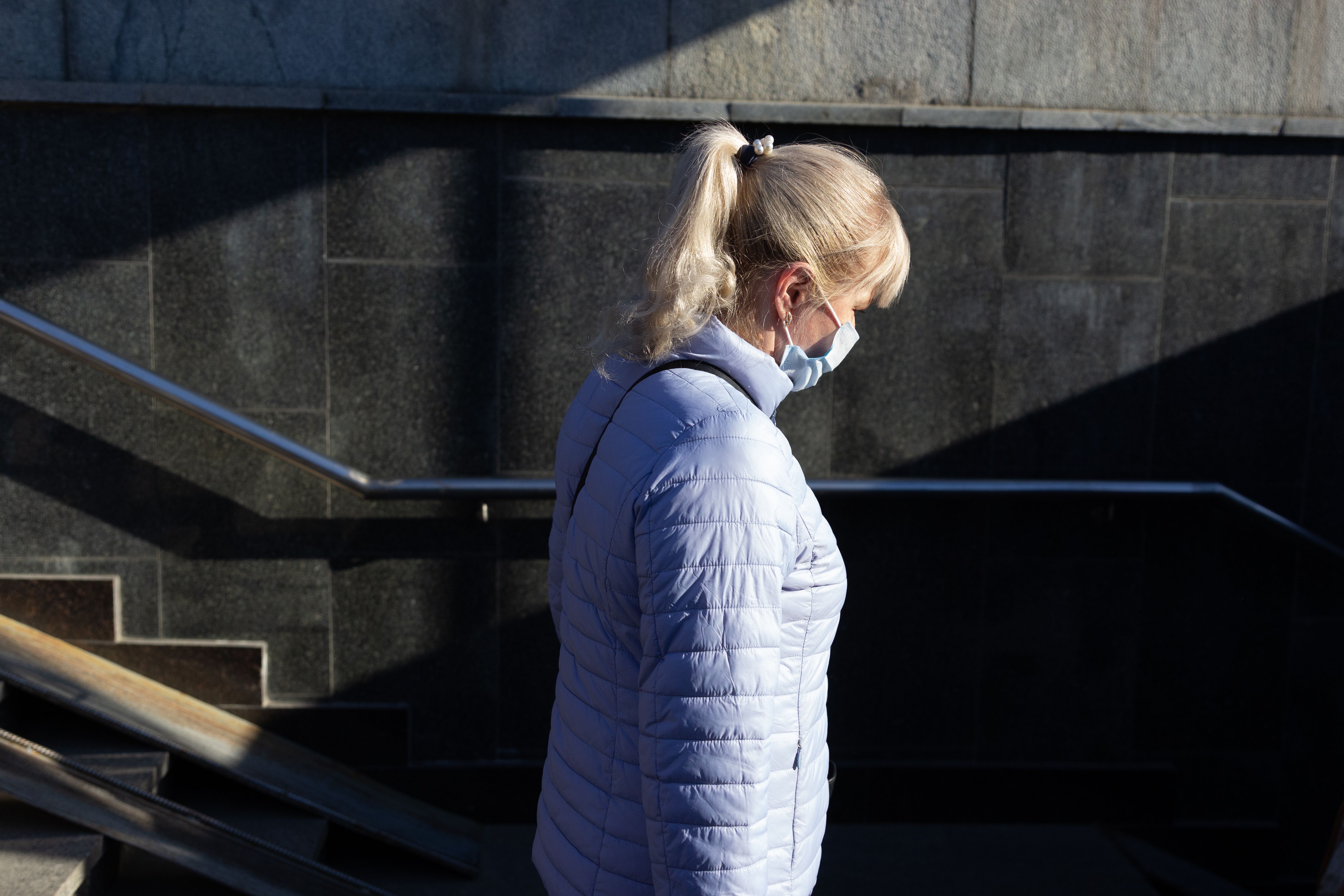 A Woman in a Jacket Wearing a Face Mask · Free Stock Photo