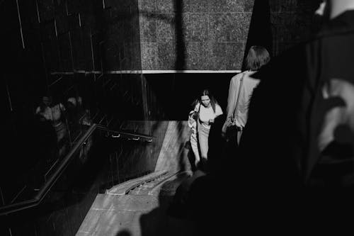 Black and White Photograph of People on Subway Steps