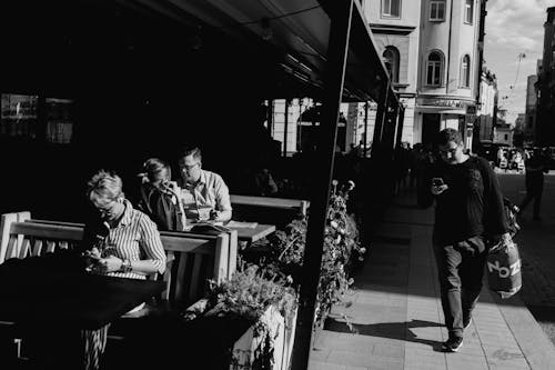 People in a Coffee Shop Near the Sidewalk