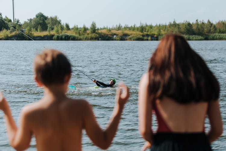 Mother And Son Watching Wake Boarding