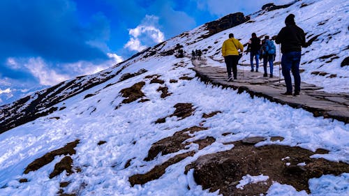 Free People Climbing the Snowy Mountain Stock Photo