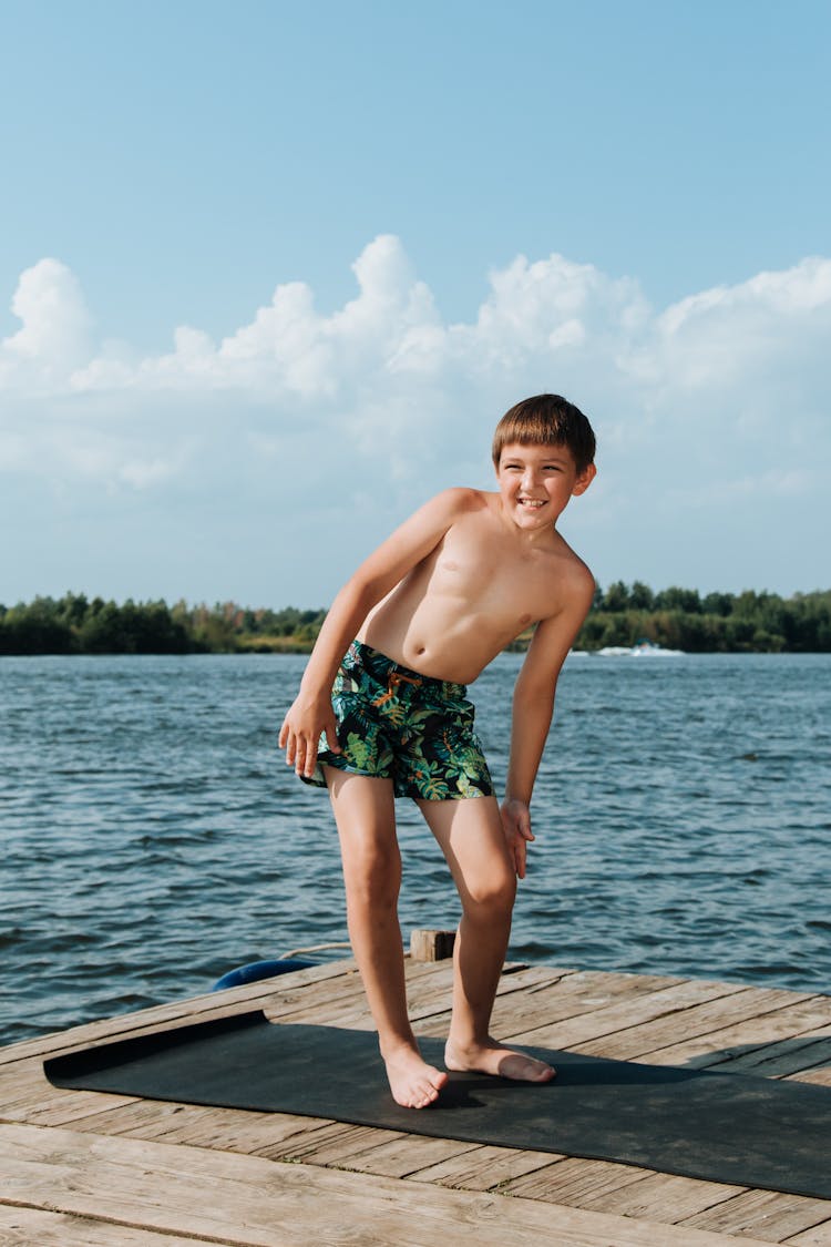 Boy Exercising On Jetty