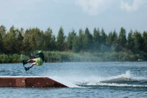 Free Exciting wakeboarding action with a rider performing a stunt on a sunny day. Stock Photo