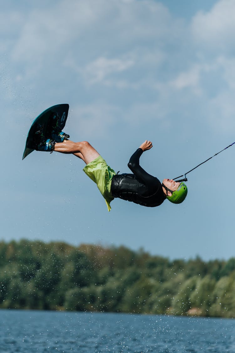 Man Doing Stunt While Wakeboarding