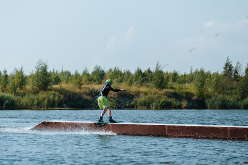 A Man Doing a Wakeboarding Trick on a Lake