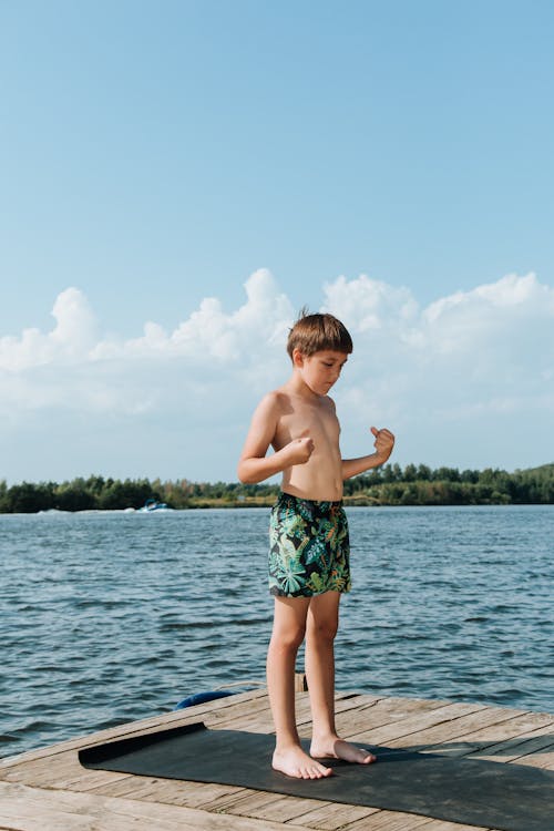 Boy Standing on Jetty in Summer