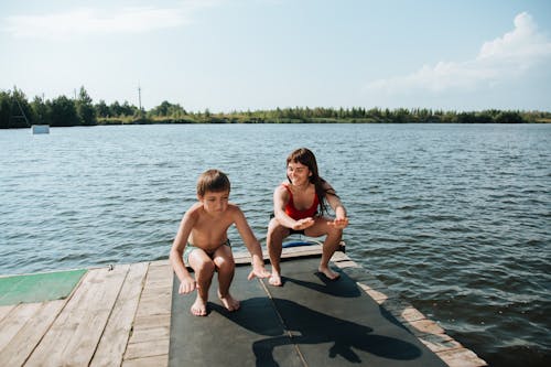 Mother and Son Exercising on Jetty