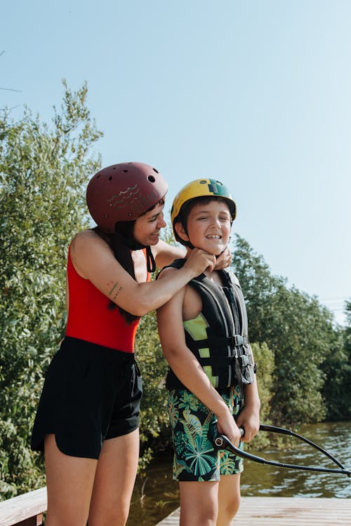 Mother Putting a Helmet on Her Kid