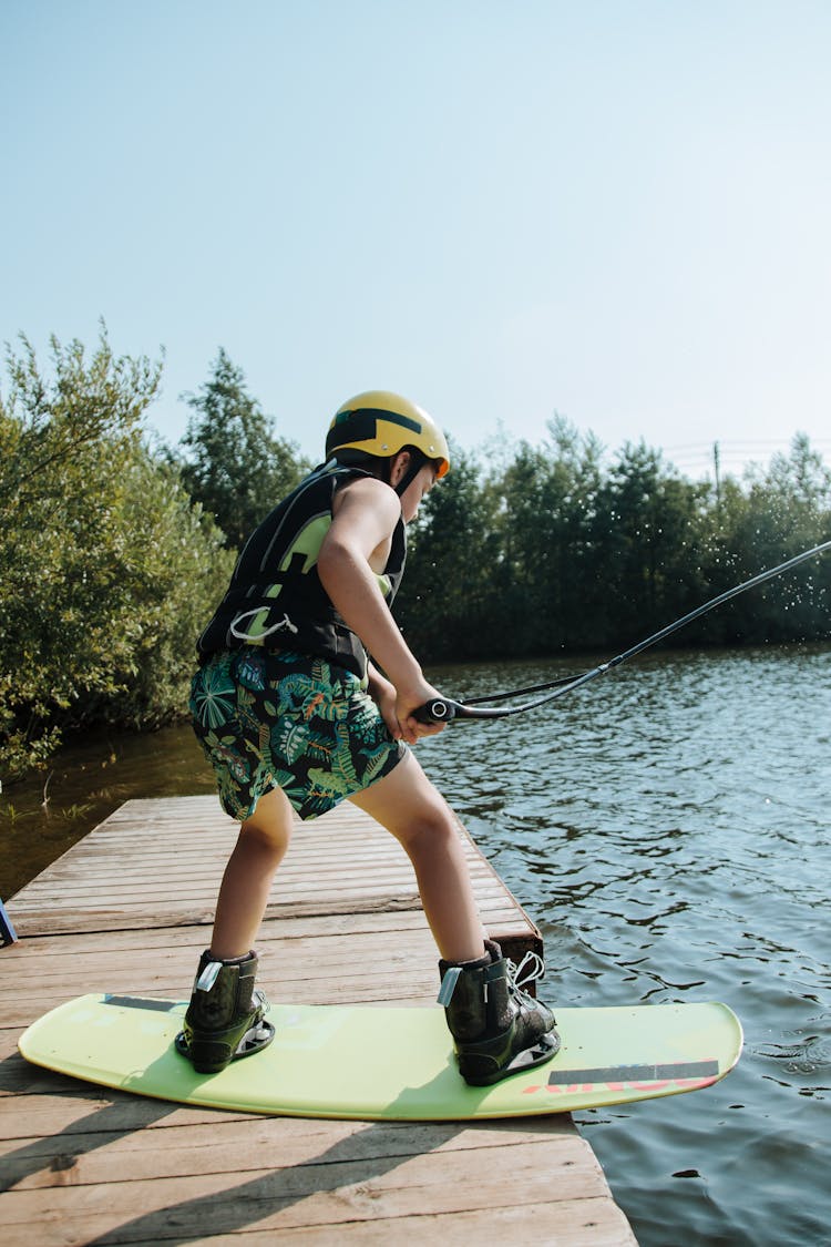 Boy On Wakeboard On Jetty