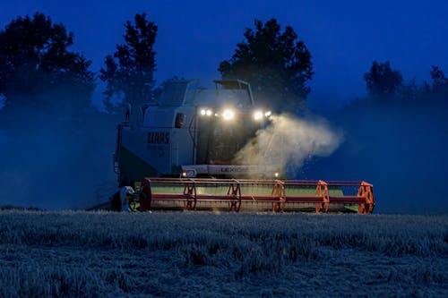 Combined Harvester on a Field at Night
