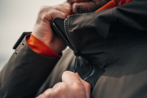 Close-Up View of Man Zipping Jacket