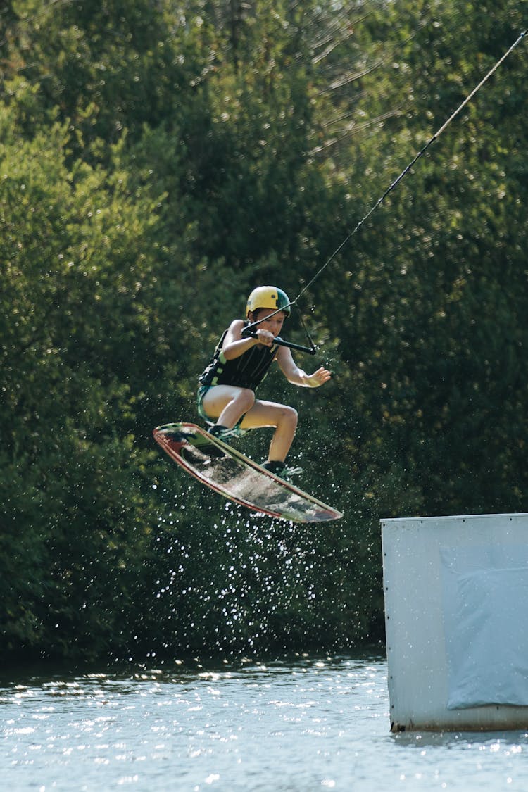 Young Kid Jumping On Wakeboard