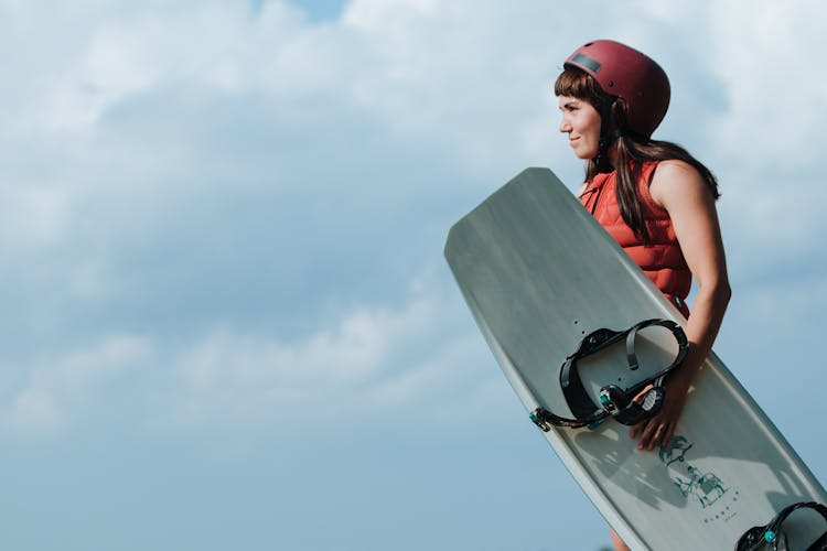 Portrait Of Woman Holding Wakeboard