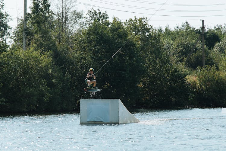 Boy Jumping On Ramp On Wakeboard