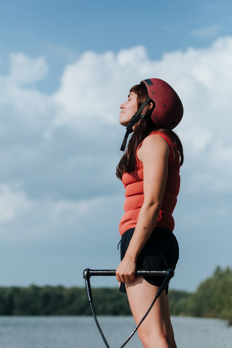 Woman In Helmet And Red Vest