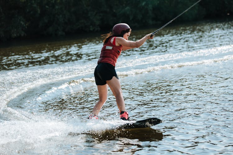 Woman Wakeboarding On Lake