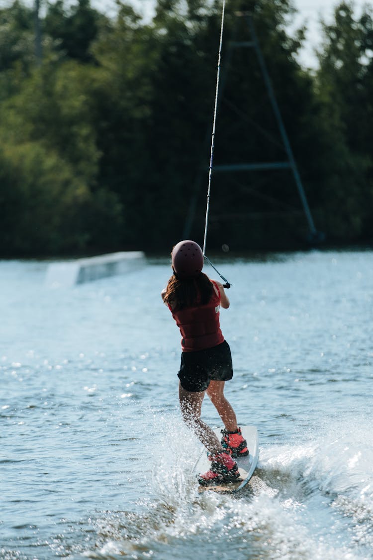 Rear View On Woman Wakeboarding