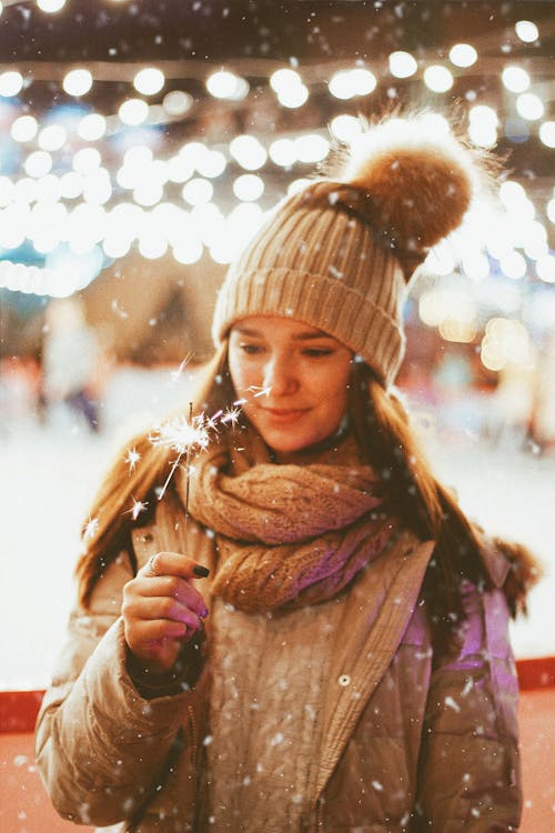 Woman Wearing Scarf Holding a Sparkler