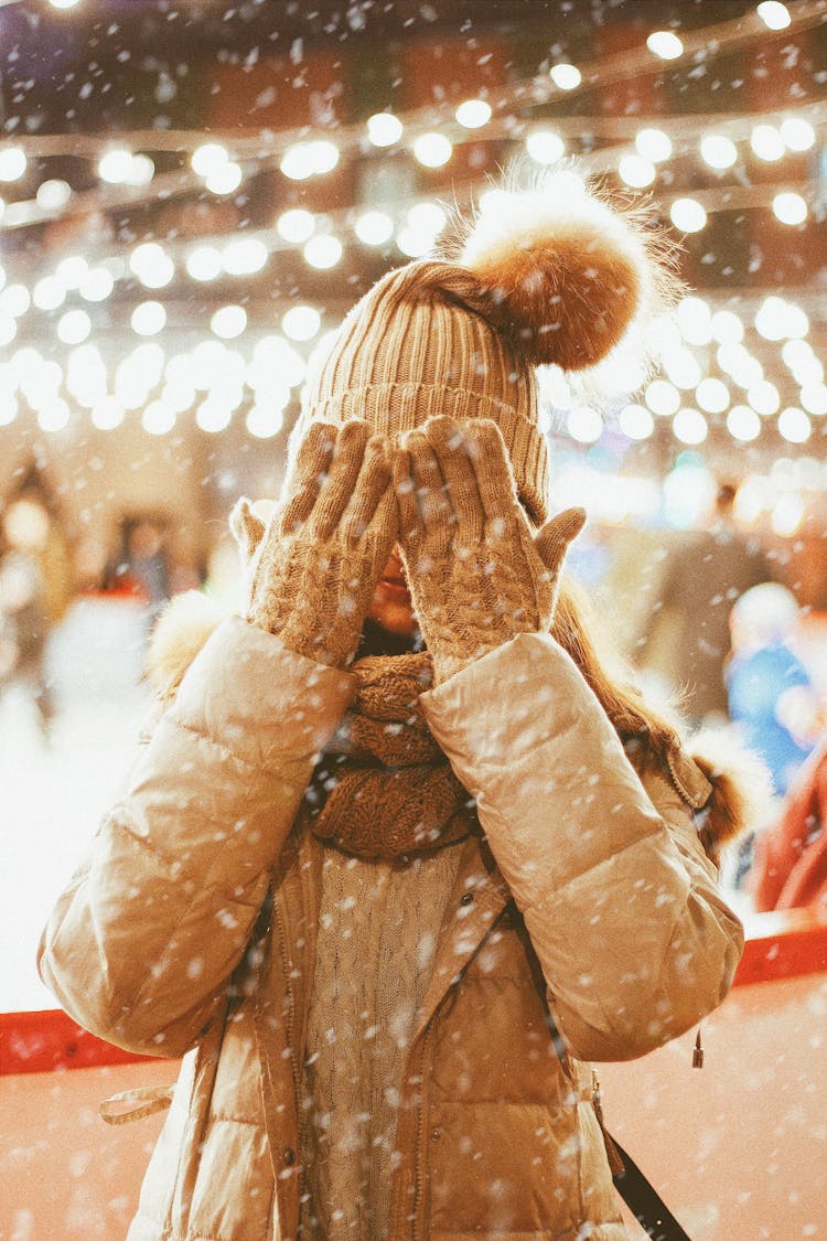 Unrecognized Girl In Winter Outfit Covering Her Face With Hands In Knitted Gloves 