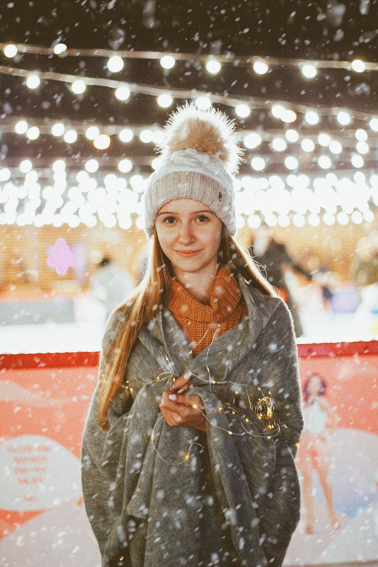 Teenage Girl In Winter Outfit With LED Lighting Wrapped Around Arms