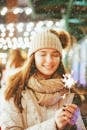 Teenage Girl in Winter Outfit Holding Sparkler in Hands