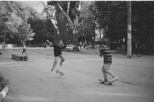 Free Grayscale Photo of Men Riding Skateboards Stock Photo