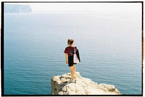 Back View of a Woman Standing on Cliff