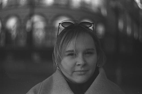 Black and White Photo of a Woman with Sunglasses on Her Head