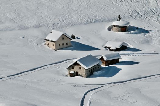 Beautiful snow-covered houses in San Vigilio, Italy during winter.