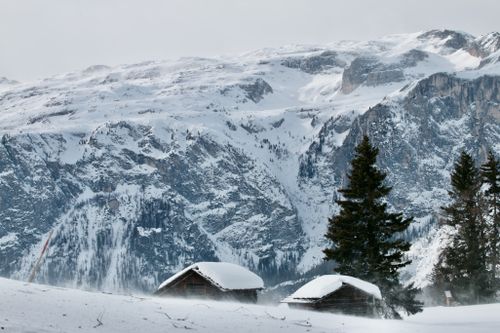 Free Breathtaking view of snow-covered mountains and cottages in La Valle, Italy. Stock Photo