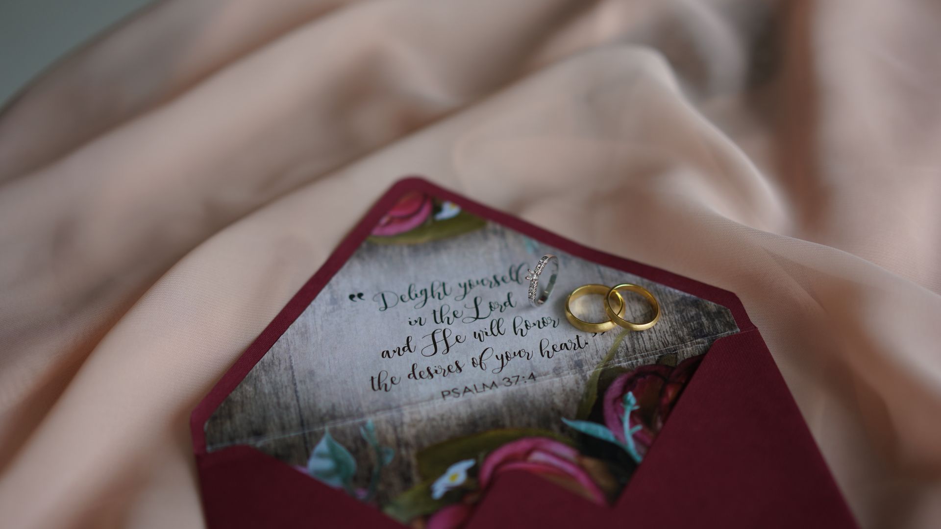 Nikkah Cards: Customise Your Special Day 3 Close-up of a wedding invitation in a burgundy envelope with gold rings and a Psalm verse — nikkah cards