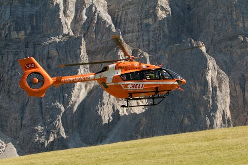 Free Rescue Helicopter Flying over Grass Field Stock Photo