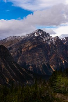 Majestic view of snow-capped mountain in Jasper National Park, Alberta under a blue sky.