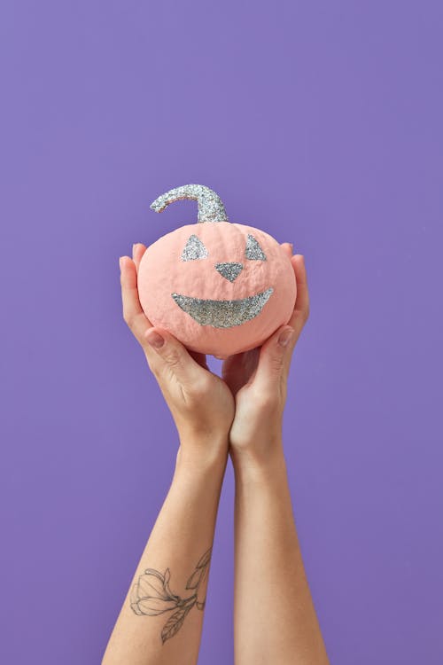 A Person Holding Pink Pumpkin