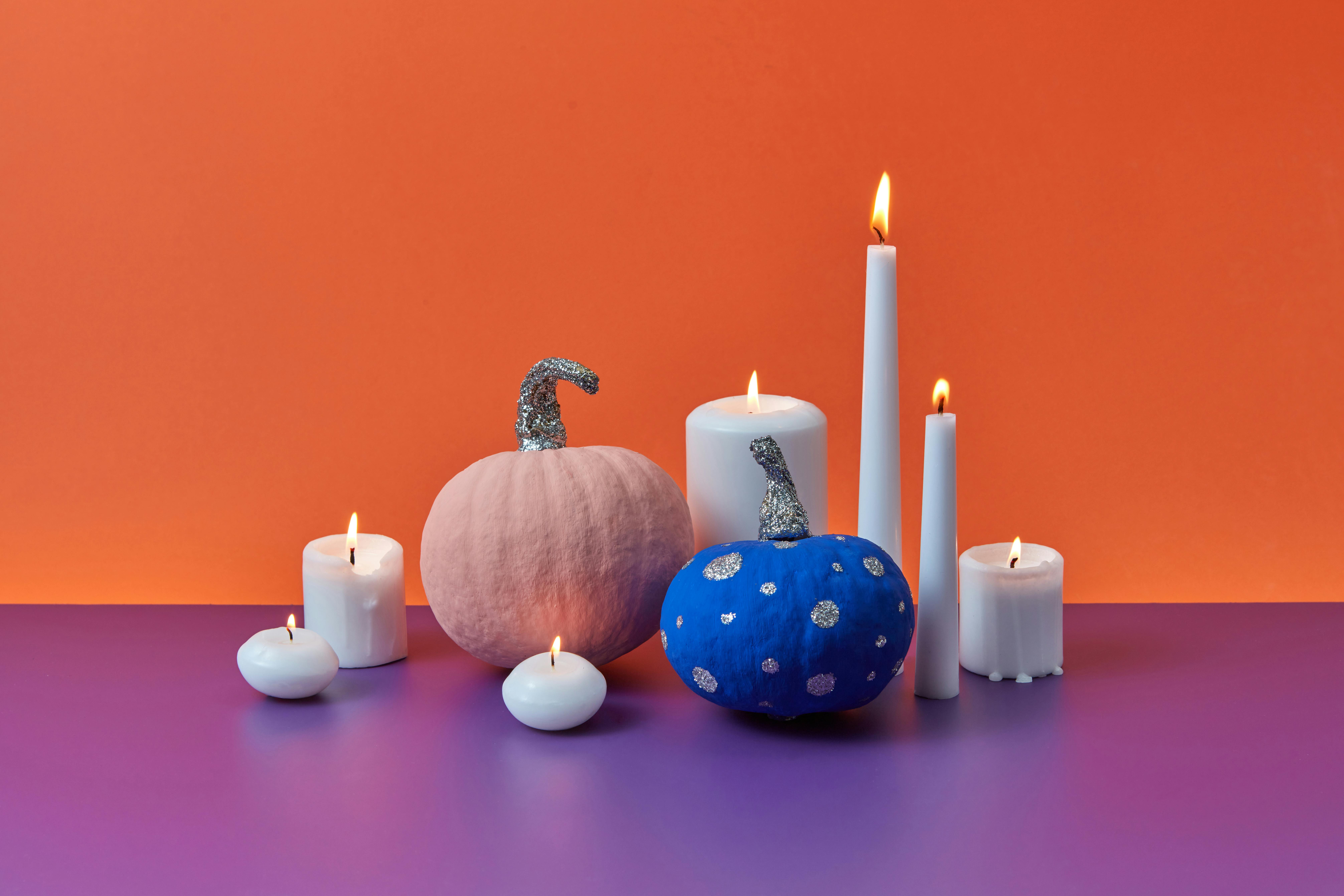 Lighted White Candles near Colored Pumpkins · Free Stock Photo