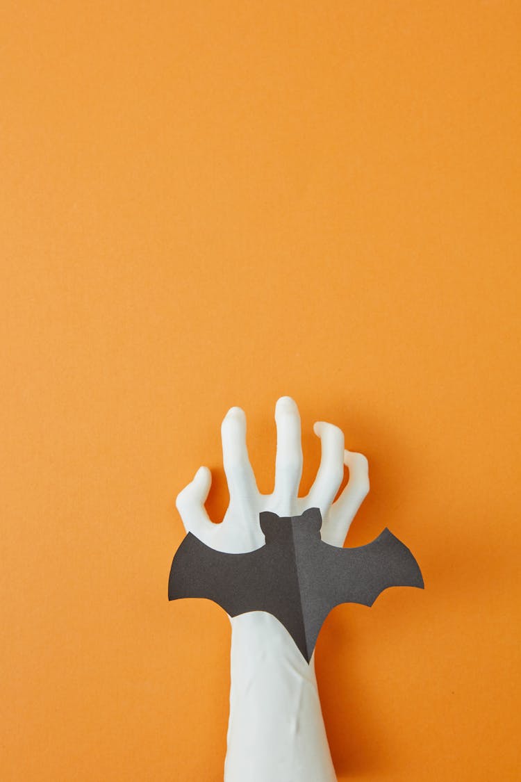 Bat Shaped Paper On White Hand 