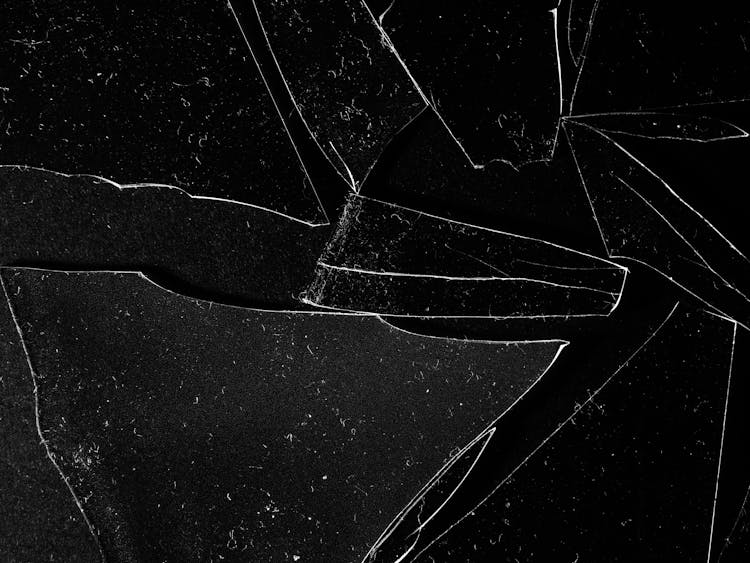 Broken Clear Glass Pieces On Black Surface